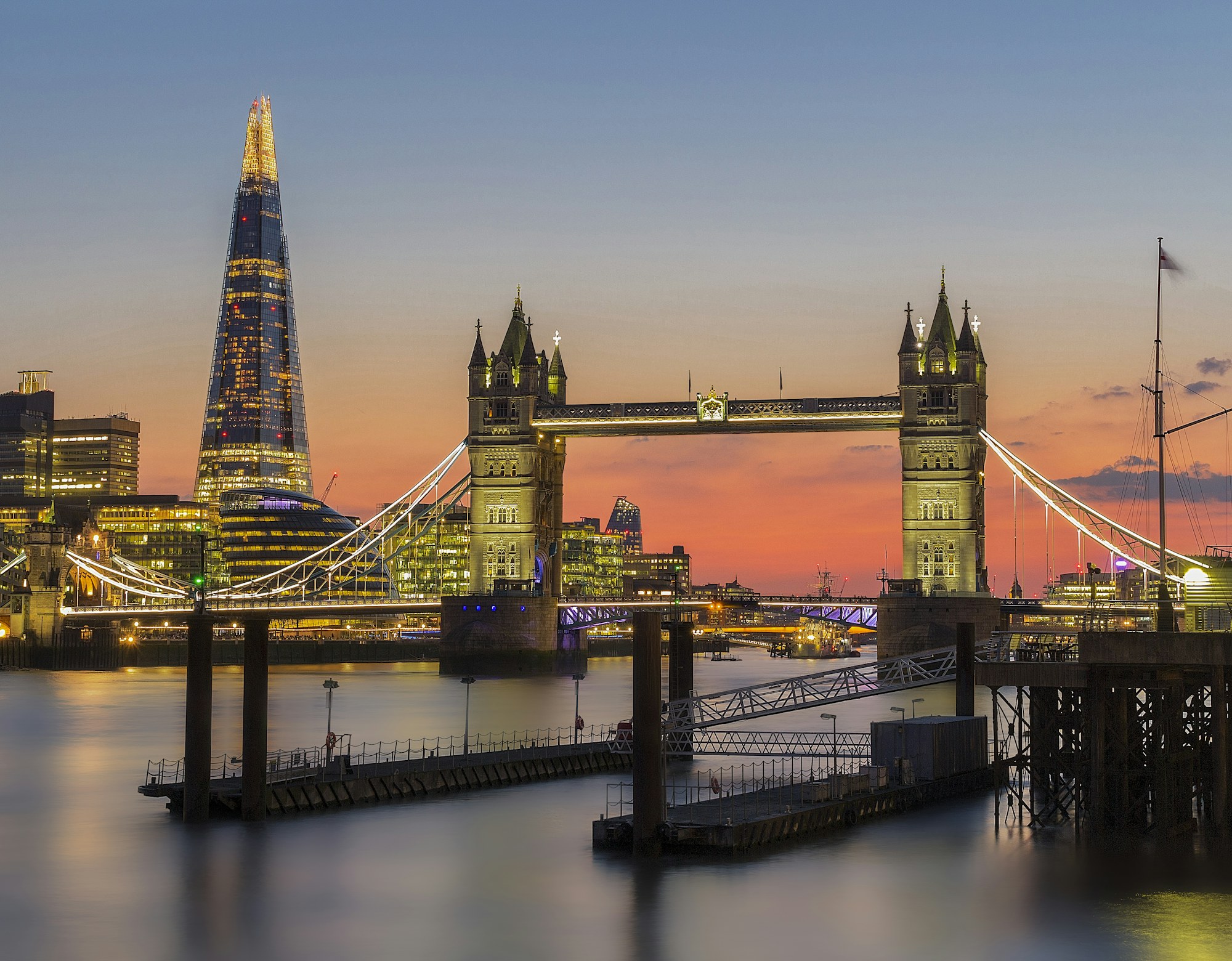Tower Bridge and the Shard glowing over the Thames at sunset